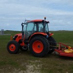 Tractor mowing the Meadows Camping Field at Mother Ivey's Bay